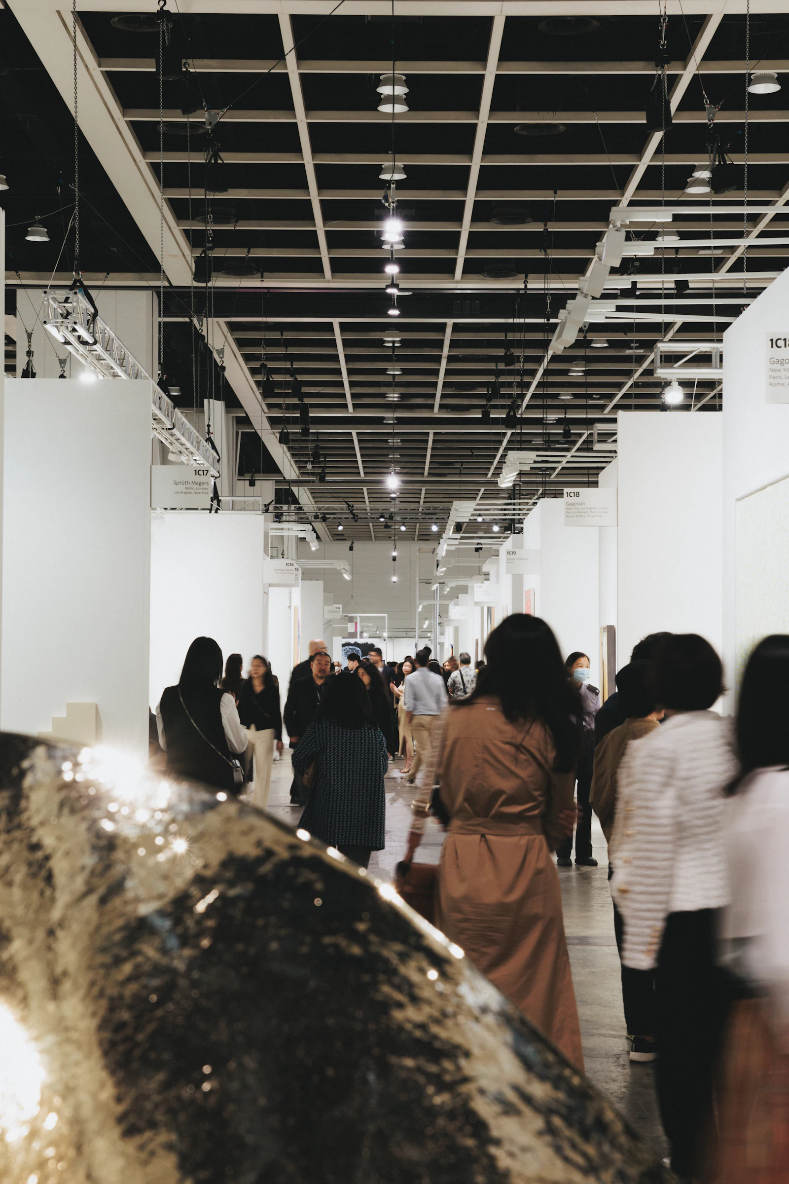 Visitors walking through a busy gallery hall