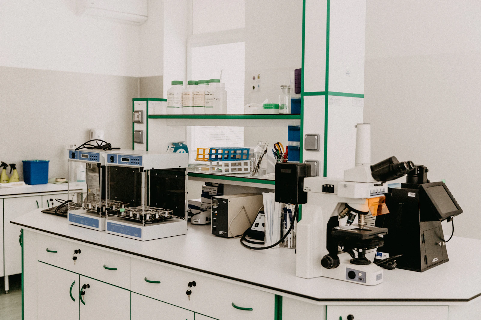 A laboratory workbench with a microscope and analytical equipment