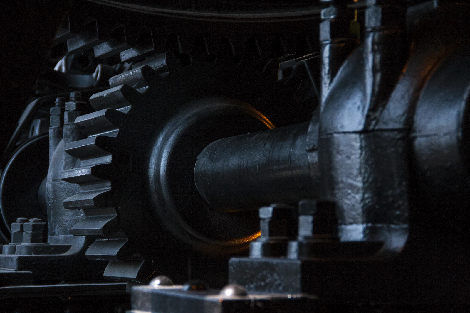 Close-up of large black metal gears meshing together