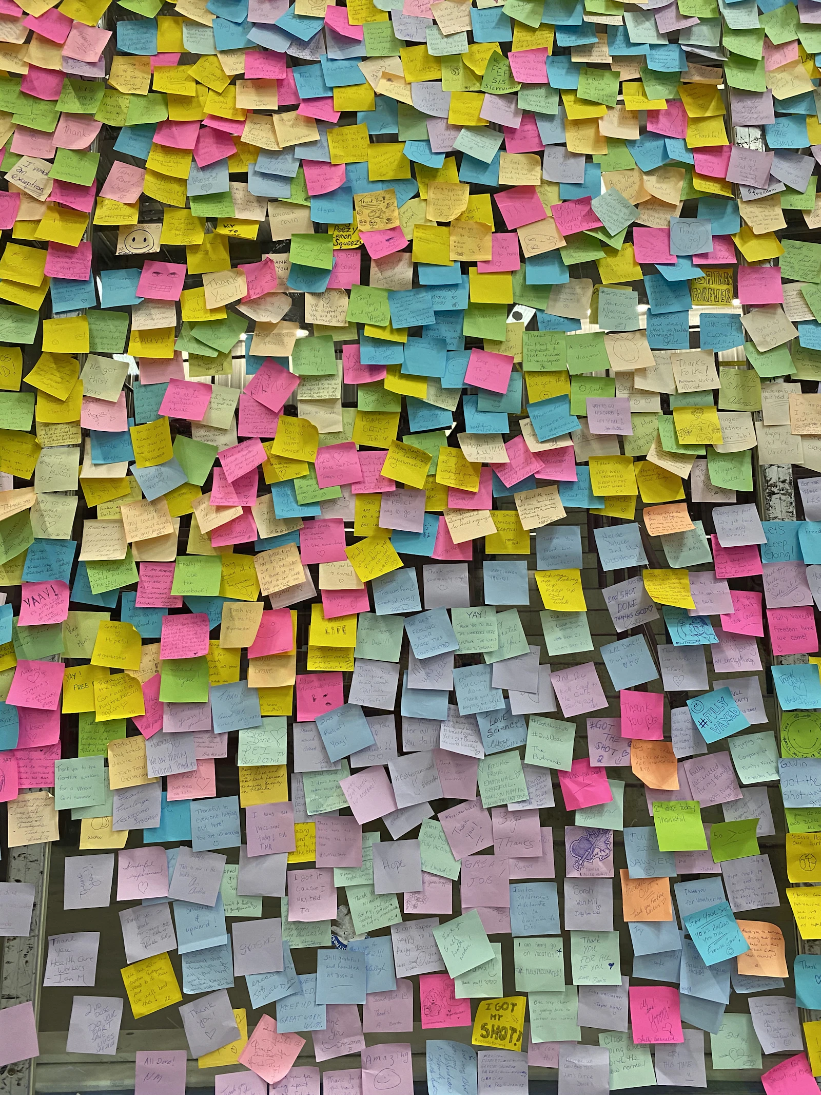 A wall covered in hundreds of colourful sticky notes